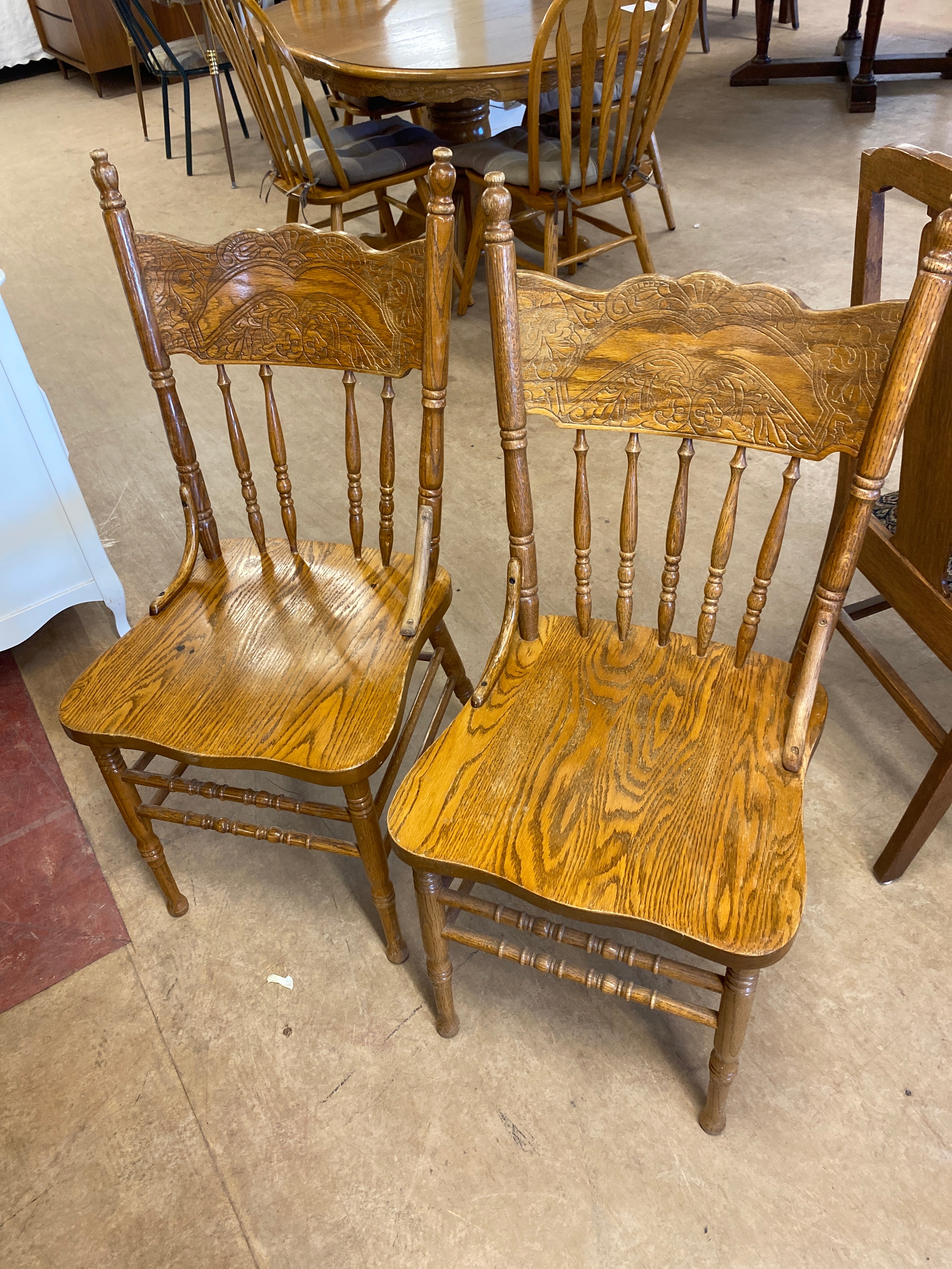 2 pressed back wooden chairs