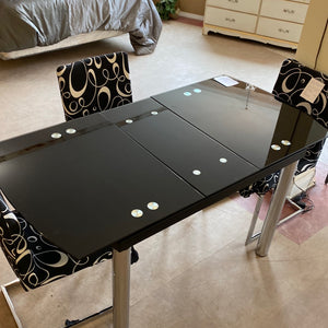 Black glass top table with hidden leaf