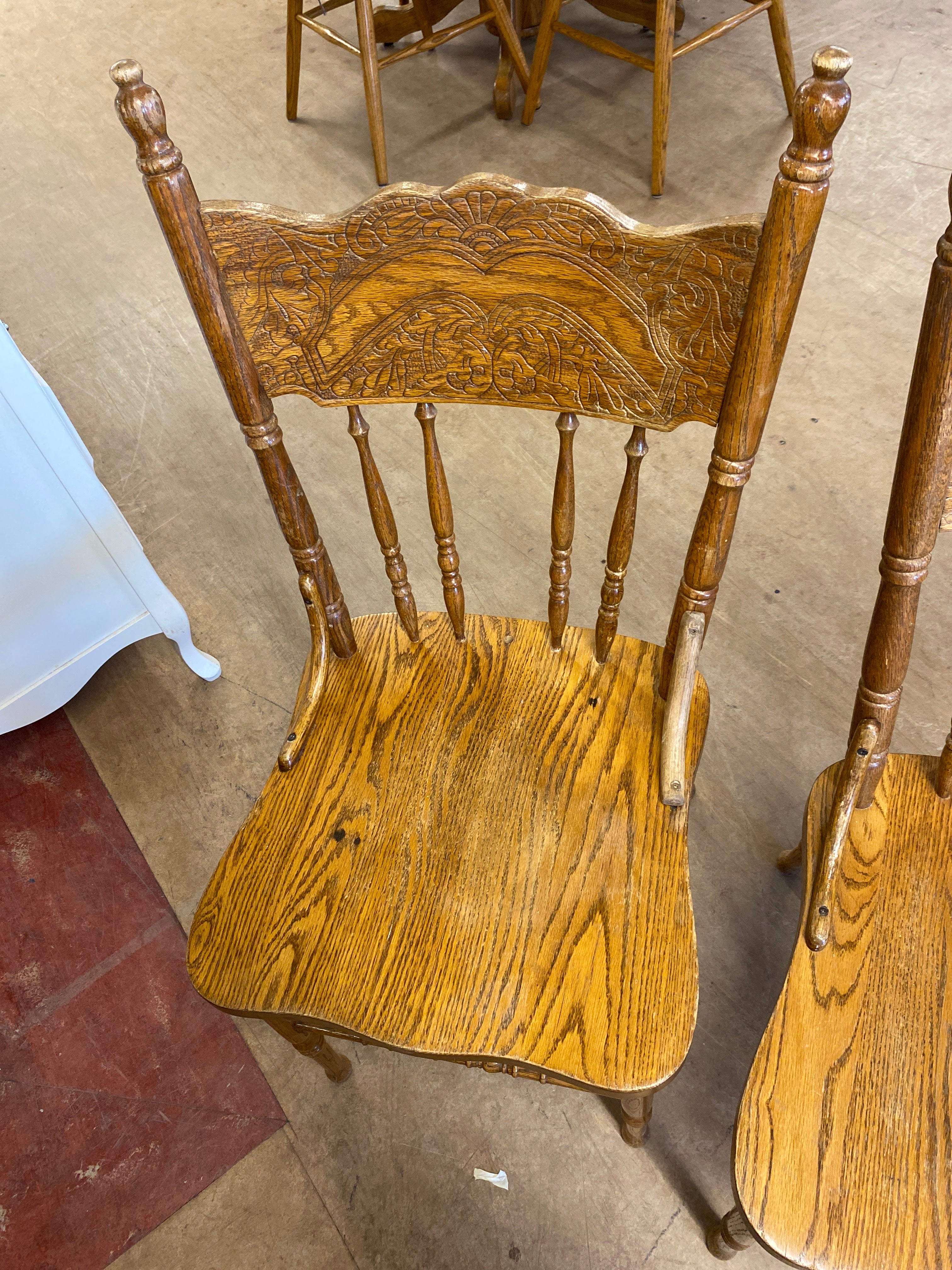 2 pressed back wooden chairs
