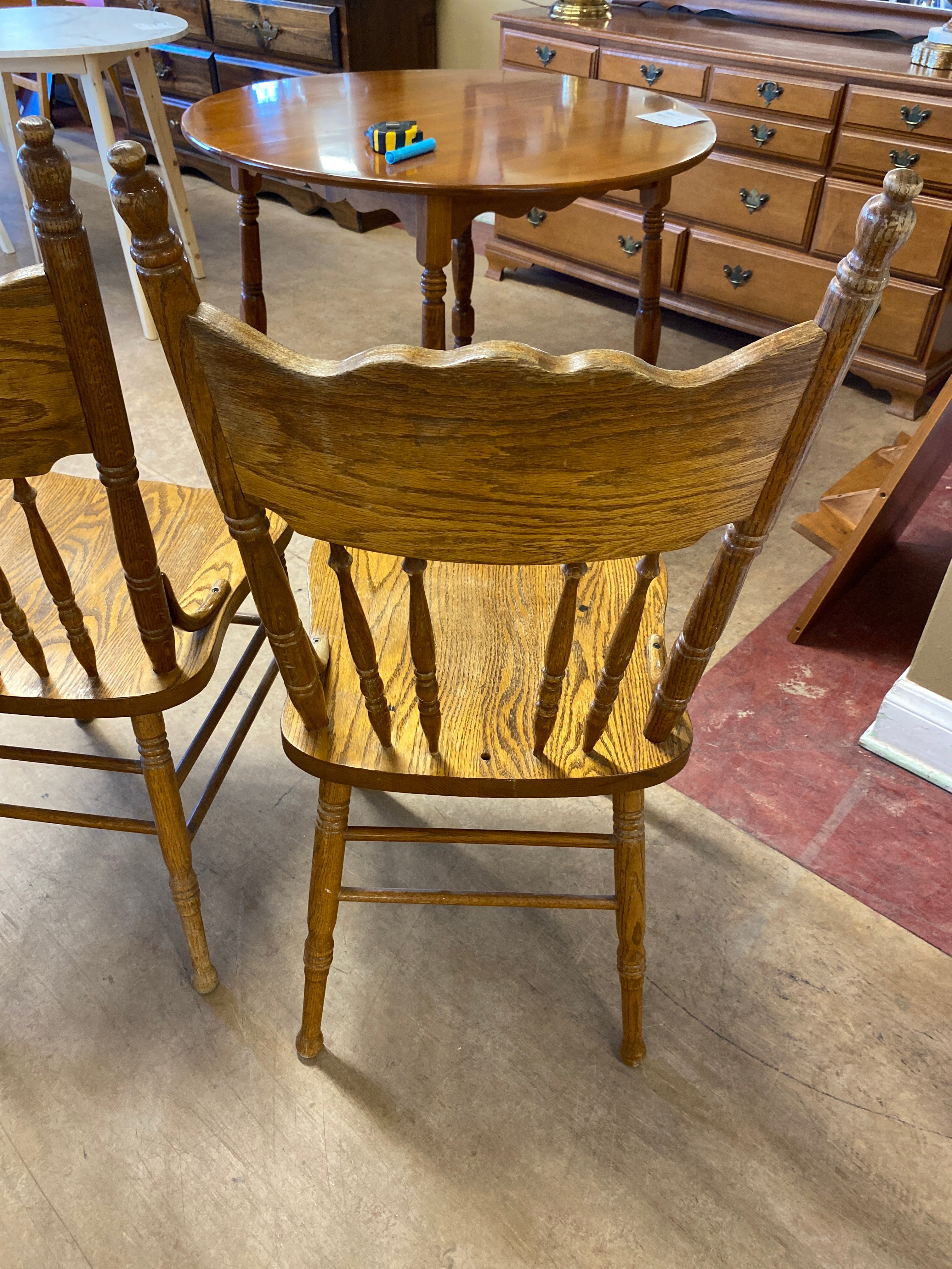 2 pressed back wooden chairs