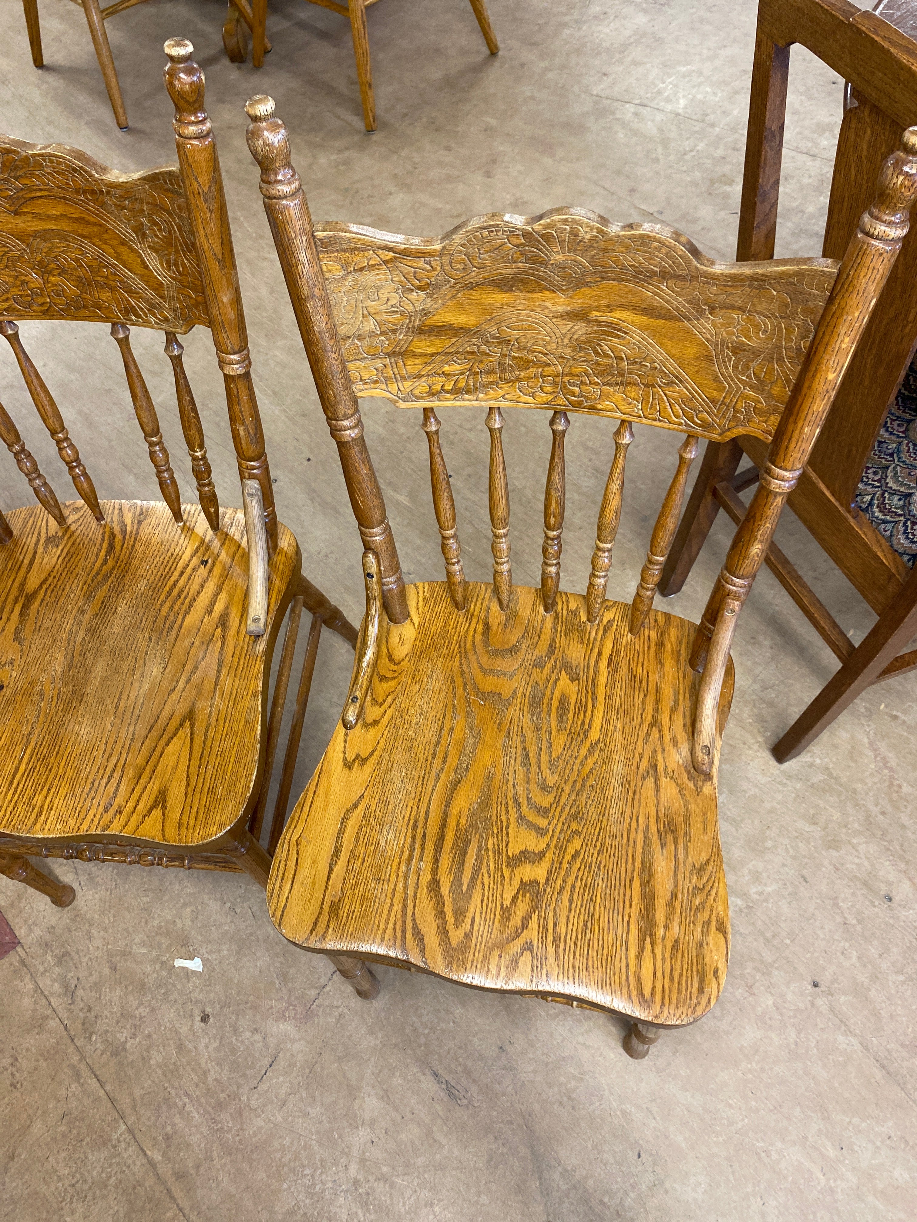 2 pressed back wooden chairs