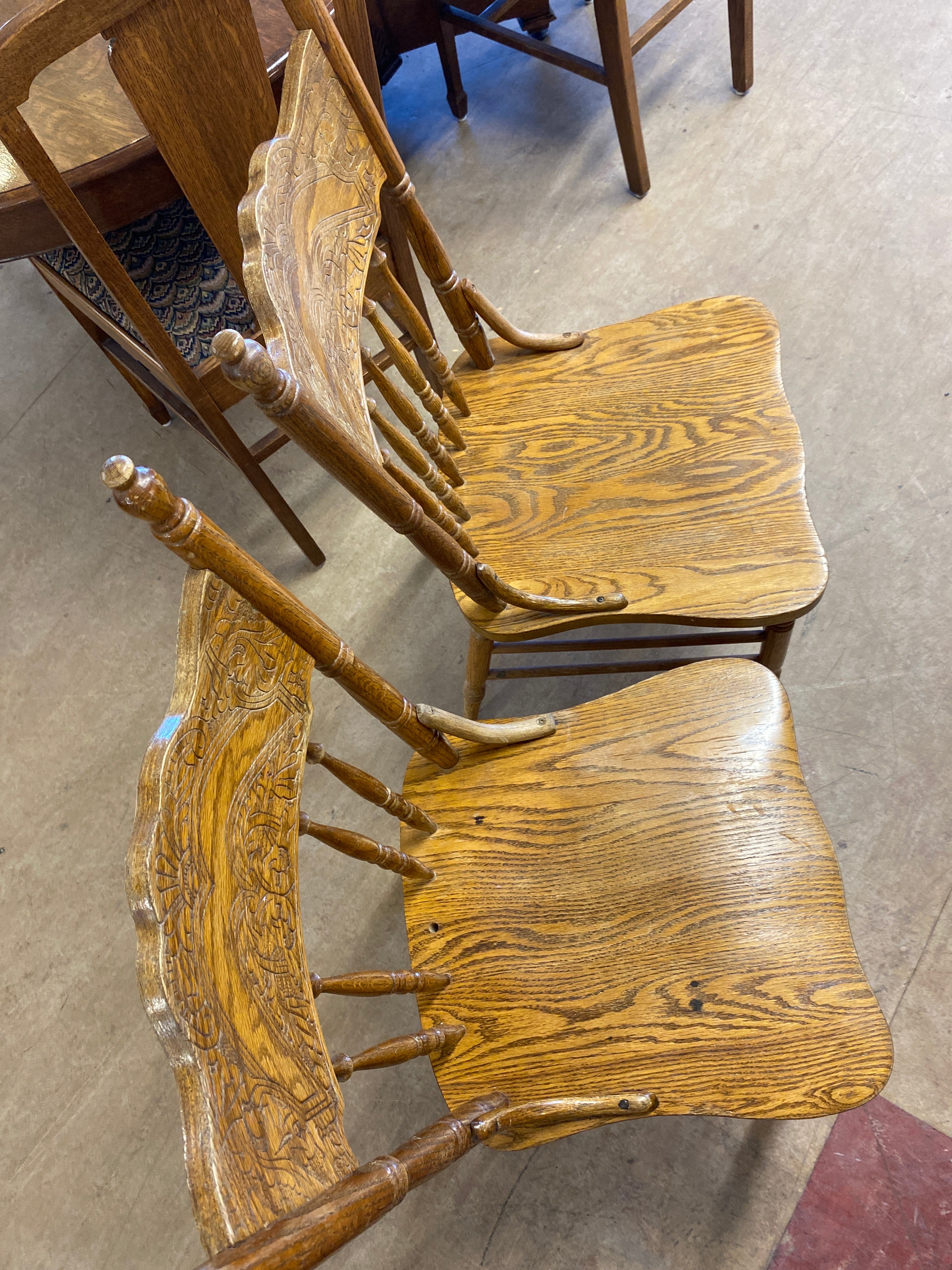 2 pressed back wooden chairs