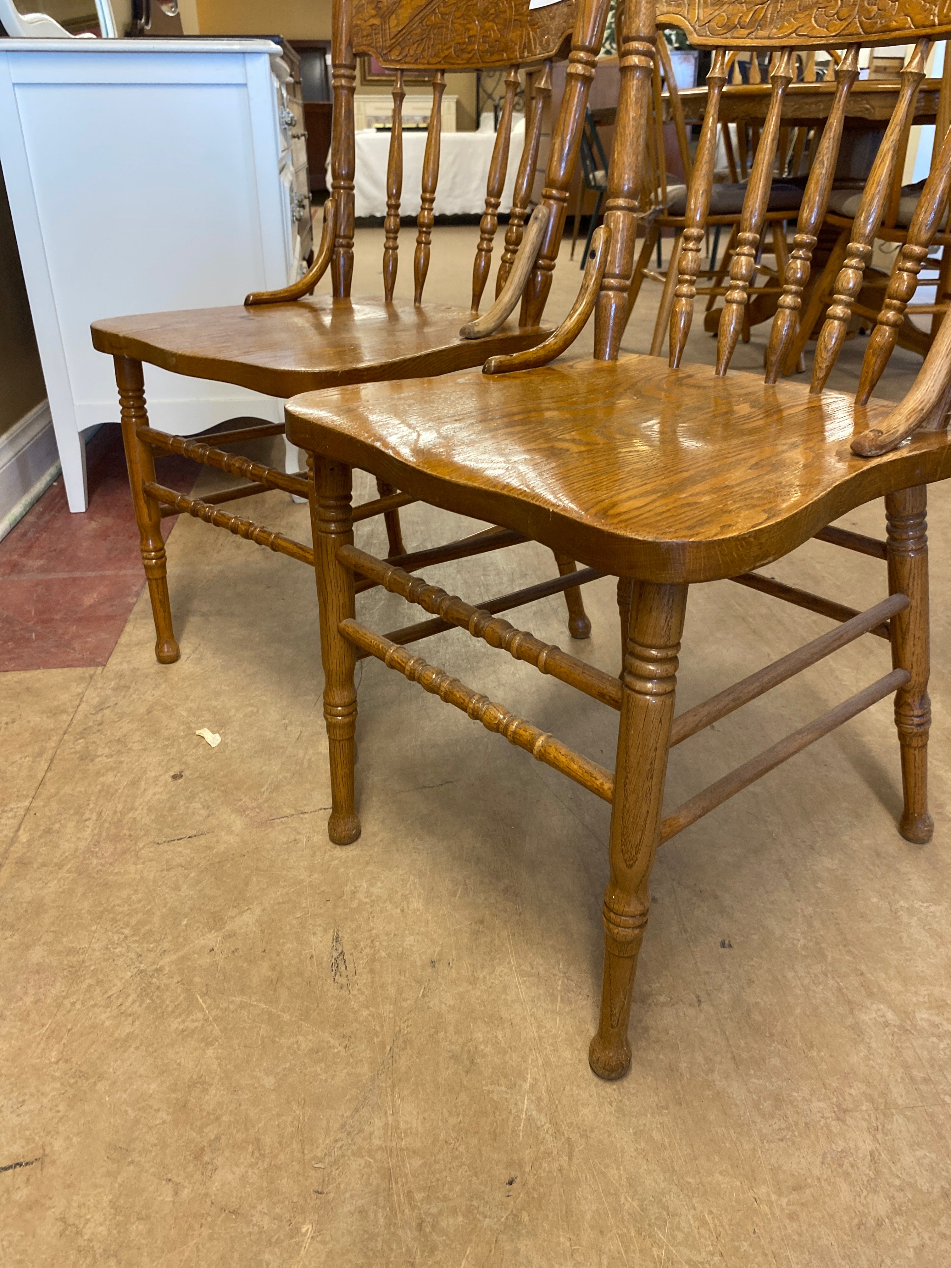 2 pressed back wooden chairs